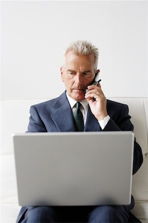 simsearch:700-03058969,k - Businessman Using Cellular Phone and Laptop Stock Photo - Rights-Managed, Code: 700-00782232
