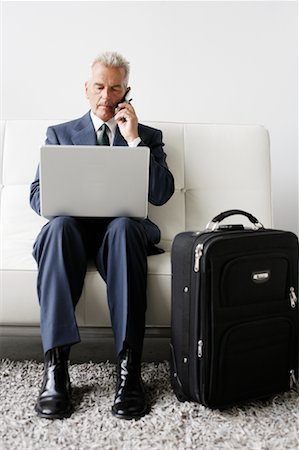 simsearch:700-03058969,k - Businessman Using Cellular Phone and Laptop on Business Trip Stock Photo - Rights-Managed, Code: 700-00782233