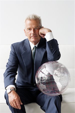 Businessman Leaning on Globe Stock Photo - Rights-Managed, Code: 700-00782342