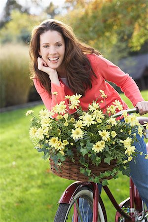 riding bike female basket - Woman on Bicycle with Flowers Stock Photo - Rights-Managed, Code: 700-00847114