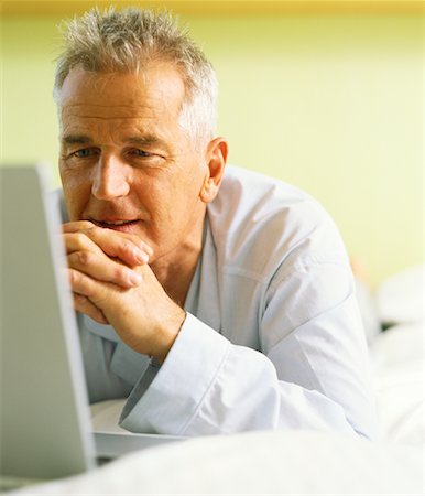 Man on Bed with Laptop Computer Stock Photo - Rights-Managed, Code: 700-00848115