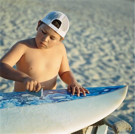 simsearch:700-00047115,k - Boy Waxing Surfboard Stock Photo - Rights-Managed, Code: 700-00864339