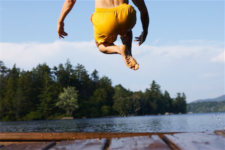 Man Jumping Off Deck Foto de stock - Con derechos protegidos, Código: 700-00867014
