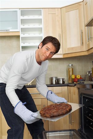 ruined food - Man Removing Burnt Food From Oven Stock Photo - Rights-Managed, Code: 700-00909724