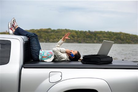 simsearch:700-00522867,k - Woman Sitting on Back of Truck Using Cell Phone Stock Photo - Rights-Managed, Code: 700-00917701