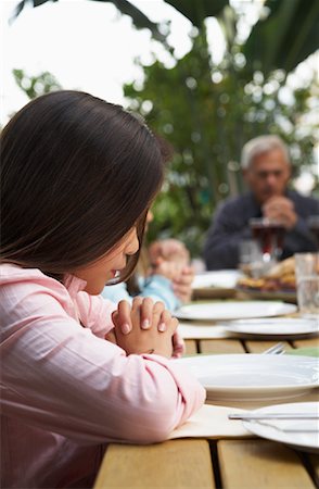 Girl With Family Saying Grace Before Dinner Outdoors Stock Photo - Rights-Managed, Code: 700-00918131