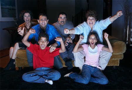 Family Watching Television And Cheering Foto de stock - Con derechos protegidos, Código: 700-00918272