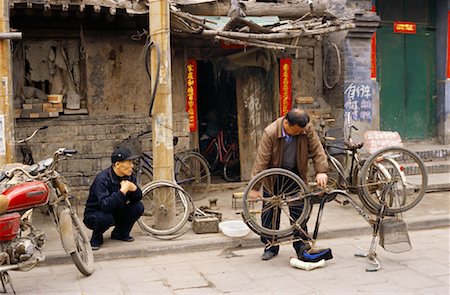 Man Fixing Bicycle, Pingyao, China Stock Photo - Rights-Managed, Code: 700-00934852