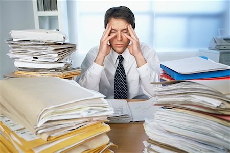 Businessman Surrounded by Paperwork Stock Photo - Rights-Managed, Code: 700-00933522