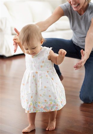 ruffle (gathered pleats) - Baby Taking First Steps Stock Photo - Rights-Managed, Code: 700-00933636