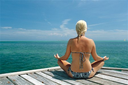 Woman Sitting on Dock Doing Yoga Foto de stock - Con derechos protegidos, Código: 700-00948352