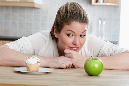 simsearch:614-06897440,k - Woman with Cupcake and Apple Stock Photo - Rights-Managed, Code: 700-01015024