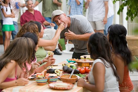 family dinner garden - Woman Feeding man at Family Gathering Stock Photo - Rights-Managed, Code: 700-01041272