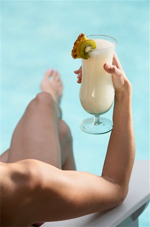 simsearch:700-01172393,k - Woman Holding Drink by Pool Stock Photo - Rights-Managed, Code: 700-01042204