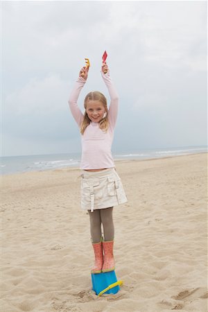 Girl Standing on Bucket on Beach Stock Photo - Rights-Managed, Code: 700-01042737