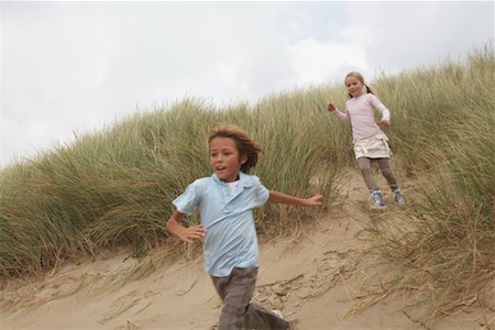 Boy and Girl Running Down Sand Dune Stock Photo - Rights-Managed, Code: 700-01042750