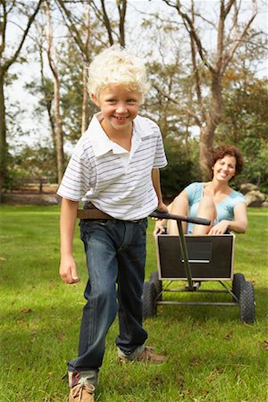 Son Pulling Mother in Wagon Stock Photo - Rights-Managed, Code: 700-01072093