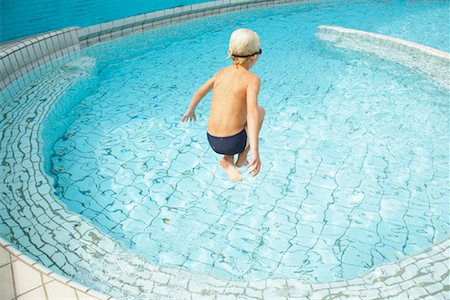 Boy Jumping into Swimming Pool Stock Photo - Rights-Managed, Code: 700-01072114