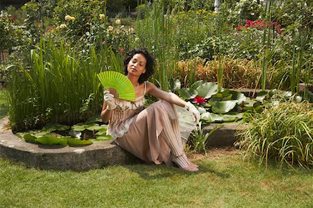 funky fashion shoot - Woman Sitting By Pond, Fanning Herself Stock Photo - Rights-Managed, Code: 700-01073607