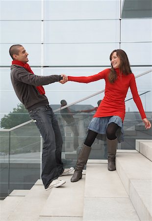 side view railings glass - Woman Pulling Man on Steps Stock Photo - Rights-Managed, Code: 700-01100286