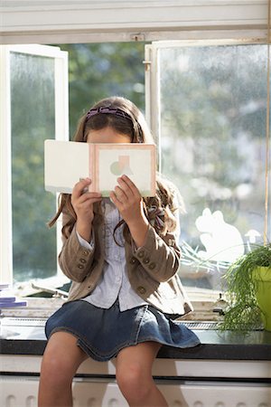 simsearch:700-01042733,k - Portrait of Girl Reading Book, Sitting by Window Stock Photo - Rights-Managed, Code: 700-01119786