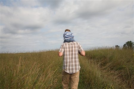 simsearch:700-00078438,k - Man Carrying Boy on Shoulders Through Field Stock Photo - Rights-Managed, Code: 700-01110293