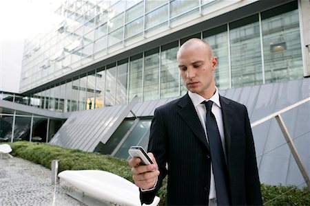 simsearch:700-01248091,k - Businessman Looking at Cell Phone Stock Photo - Rights-Managed, Code: 700-01164540