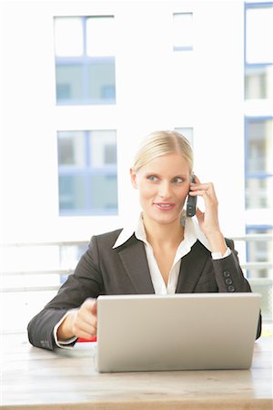 simsearch:700-01198981,k - Businesswoman Talking on Cellular Phone and Using Laptop Computer Stock Photo - Rights-Managed, Code: 700-01165057