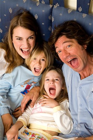 Family Reading in Bed Stock Photo - Rights-Managed, Code: 700-01172875