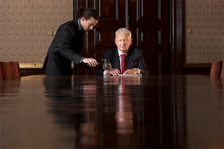 Servant Pouring Drink for Businessman Stock Photo - Rights-Managed, Code: 700-01184964