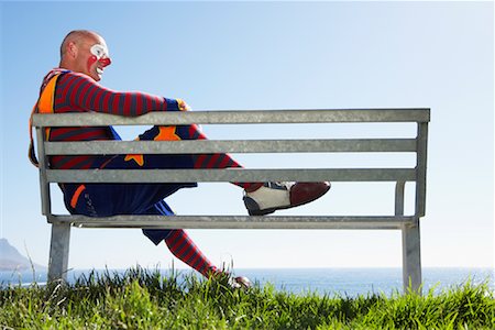 simsearch:700-01185219,k - Clown Sitting on Bench Outdoors Stock Photo - Rights-Managed, Code: 700-01185209