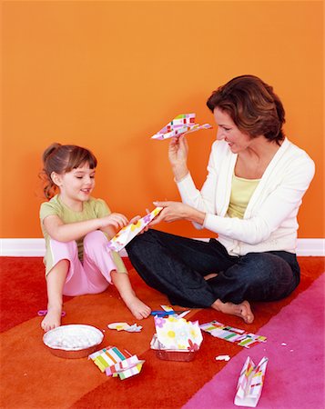 parents sitting with kids for crafts - Mother and Daughter Making Paper Airplanes Stock Photo - Rights-Managed, Code: 700-01194574