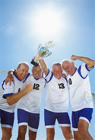 football players lifting teammate - Soccer Players With Trophy Stock Photo - Rights-Managed, Code: 700-01199275