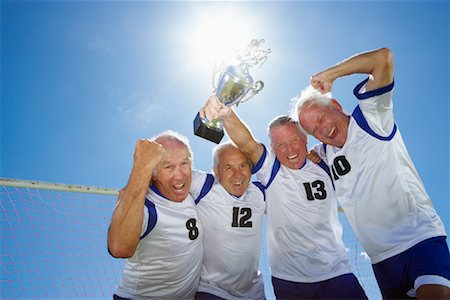 football players lifting teammate - Soccer Players With Trophy Stock Photo - Rights-Managed, Code: 700-01199276