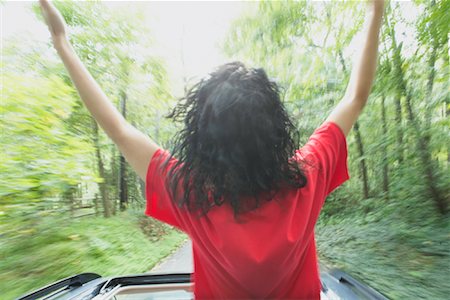 Woman Standing Up Out of Sunroof of Moving Car Stock Photo - Rights-Managed, Code: 700-01199496