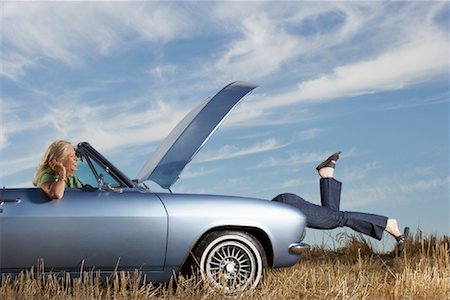 Woman Looking Under Hood of Stalled Car Stock Photo - Rights-Managed, Code: 700-01199947