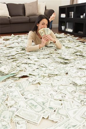 Woman at Home with Pile of Money Stock Photo - Rights-Managed, Code: 700-01200185