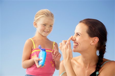 Girl Putting Sunscreen on Mother Stock Photo - Rights-Managed, Code: 700-01223324