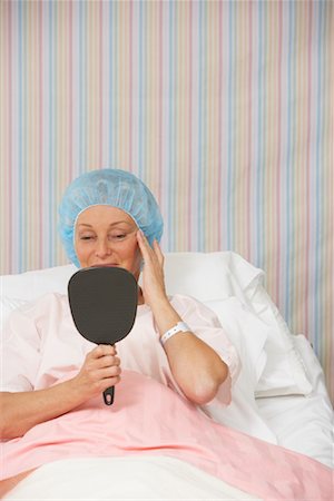 Woman in Hospital Bed, Looking at Mirror Stock Photo - Rights-Managed, Code: 700-01236119