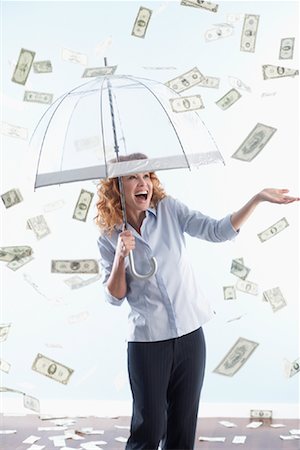 Woman Holding Umbrella with Raining Money Stock Photo - Rights-Managed, Code: 700-01249279