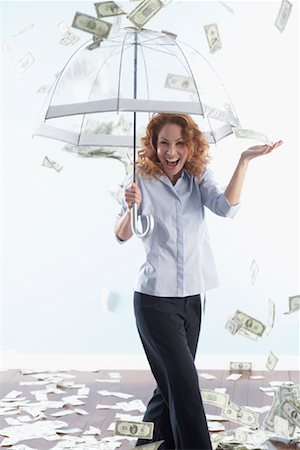 Woman Holding Umbrella with Raining Money Stock Photo - Rights-Managed, Code: 700-01249281
