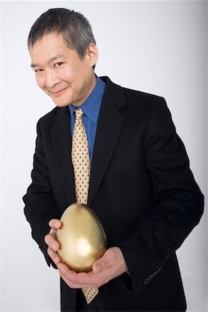 displays for gold photos - Businessman with Golden Egg Stock Photo - Rights-Managed, Code: 700-01276271