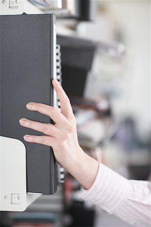 Businesswoman Reaching for File Folders Stock Photo - Rights-Managed, Code: 700-01464219