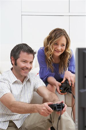simsearch:6108-06905230,k - Father and Daughter Playing Video Games Stock Photo - Rights-Managed, Code: 700-01463724