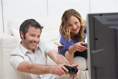 simsearch:6108-06905230,k - Father and Daughter Playing Video Games Stock Photo - Rights-Managed, Code: 700-01463723