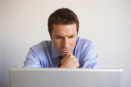 simsearch:700-00045560,k - Businessman Looking at Laptop Computer Stock Photo - Rights-Managed, Code: 700-01494714