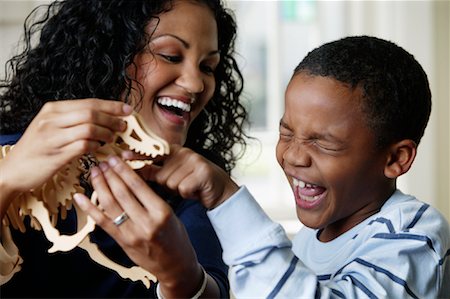 Mother and Son Playing with Dinosaur Toy Stock Photo - Rights-Managed, Code: 700-01519695