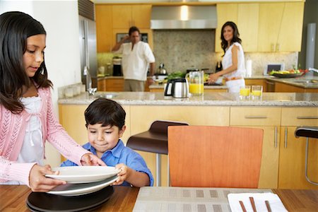 setting kitchen table - Family Setting Table Stock Photo - Rights-Managed, Code: 700-01579448