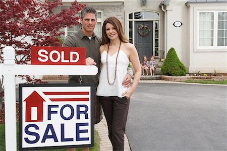 Portrait of Couple by House with Sold Sign Stock Photo - Rights-Managed, Code: 700-01571957