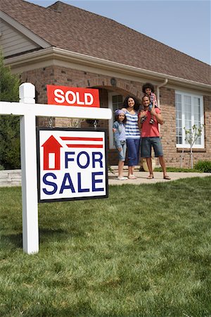 Portrait of Family by House with Sold Sign Stock Photo - Rights-Managed, Code: 700-01571974